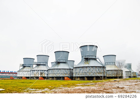 Large cooling towers in water and fog at an oil 69284226