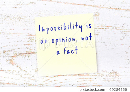 Wise quote on sticky note on wooden wall  69284566
