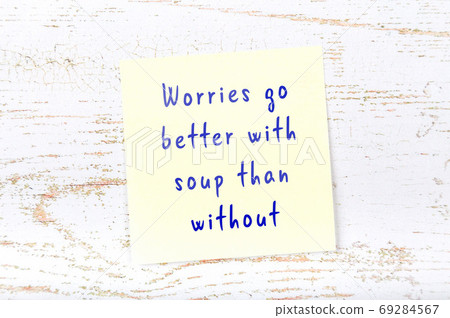 Wise quote on sticky note on wooden wall Wise quote on sticky note on wooden wall 69284567