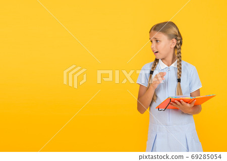 Some troubles. Cute small child reading book on yellow Some troubles. Cute small child reading book on yellow 69285054