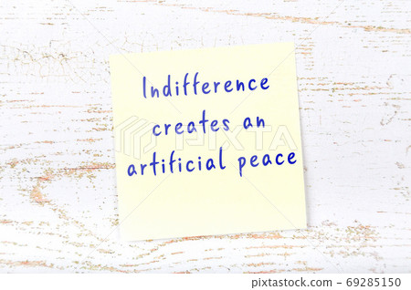 Wise quote on sticky note on wooden wall  69285150