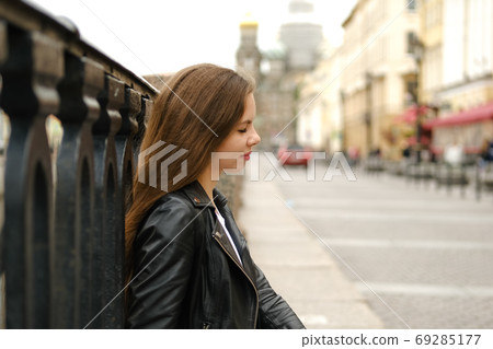 Young woman walking along the streets of a big city. 69285177