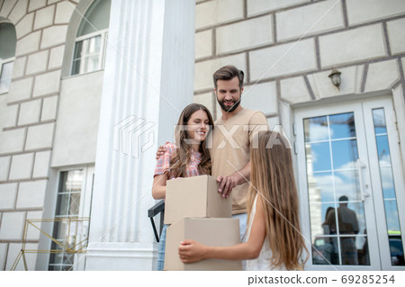 Young family standing near boxes and feeling contented 69285254