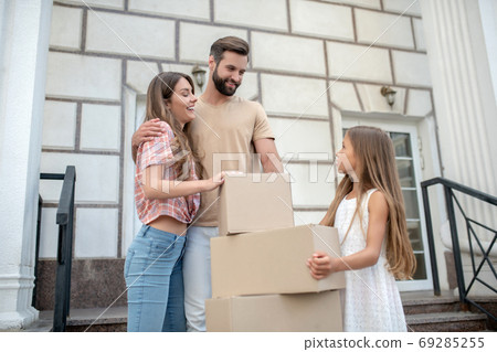 Young family standing near boxes and feeling excited 69285255