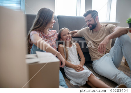 Family resting on the sofa and smiling Family resting on the sofa and smiling 69285404