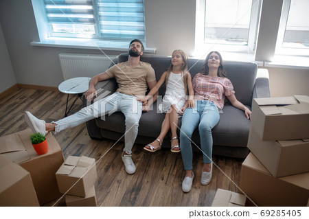 Family sitting on the sofa and looking tired 69285405