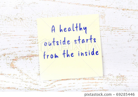 Yellow sticky note on wooden wall with wise quote Yellow sticky note on wooden wall with wise quote 69285446