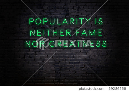 Wise quote. Neon inscription against brick wall 69286266