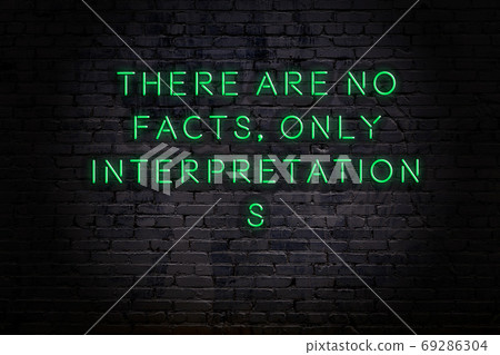 Wise quote. Neon inscription against brick wall Wise quote. Neon inscription against brick wall 69286304