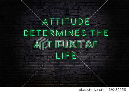 Wise quote. Neon inscription against brick wall Wise quote. Neon inscription against brick wall 69286358