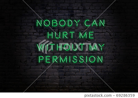 Wise quote. Neon inscription against brick wall 69286359