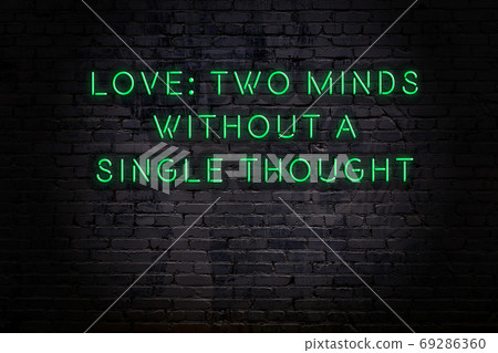 Wise quote. Neon inscription against brick wall 69286360