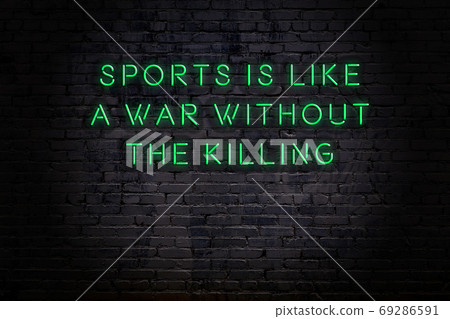 Wise quote. Neon inscription against brick wall 69286591