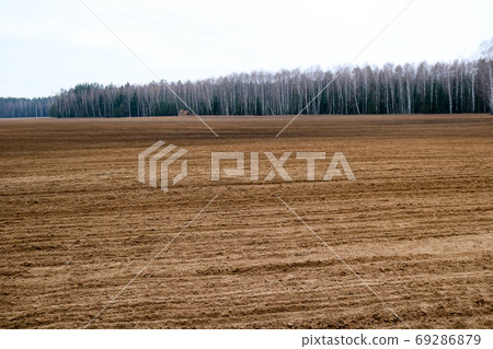 Landscape field, brown dug up land with beds Landscape field, brown dug up land with beds 69286879