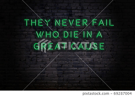 Wise quote. Neon inscription against brick wall 69287004