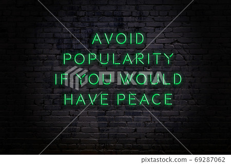 Wise quote. Neon inscription against brick wall 69287062