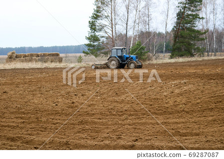 Blue tractor, agrimotor sows crops, performs 69287087