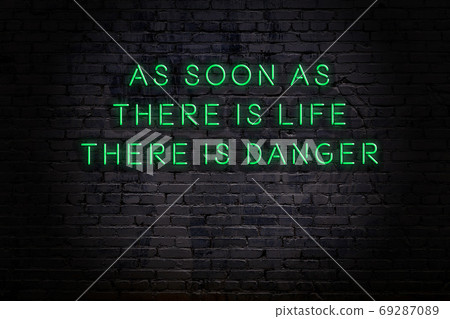 Wise quote. Neon inscription against brick wall 69287089