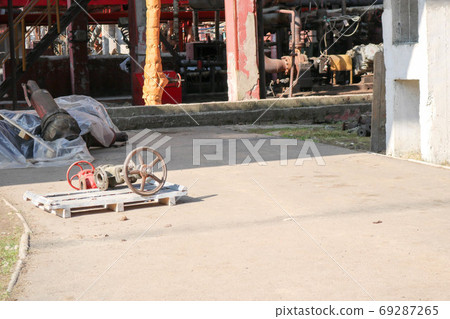 Rusty pipeline valves with flanges on a wooden Rusty pipeline valves with flanges on a wooden 69287265