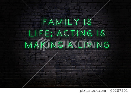 Wise quote. Neon inscription against brick wall Wise quote. Neon inscription against brick wall 69287301