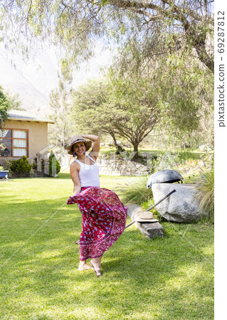 Pretty woman dancing flamenco in the garden of the house Pretty woman dancing flamenco in the garden of the house 69287812