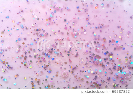 Texture of pink gel with sparkles. Glitter texture with sequins. Nail polish gel. 69287832