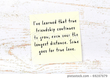 Yellow sticky note on wooden wall with wise quote Yellow sticky note on wooden wall with wise quote 69287879