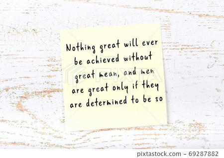 Yellow sticky note on wooden wall with wise quote Yellow sticky note on wooden wall with wise quote 69287882