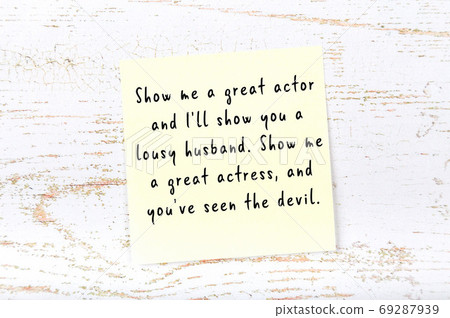 Yellow sticky note on wooden wall with wise quote 69287939