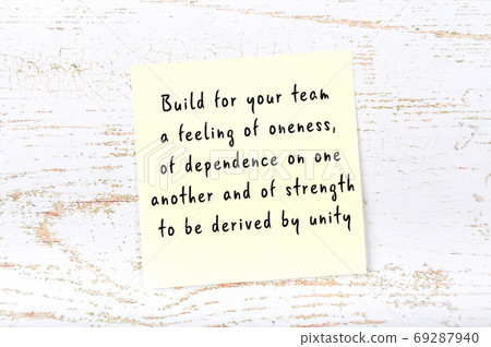 Wise quote on sticky note on wooden wall  69287940