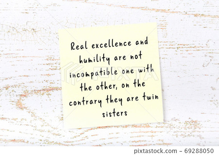 Yellow sticky note on wooden wall with wise quote Yellow sticky note on wooden wall with wise quote 69288050