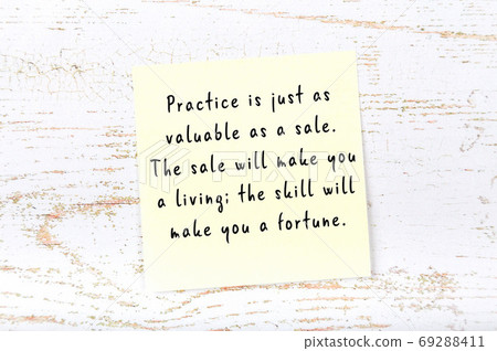 Wise quote on sticky note on wooden wall Wise quote on sticky note on wooden wall 69288411