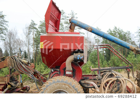 The grain falls into a large seeding unit The grain falls into a large seeding unit 69288412