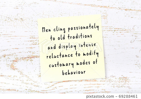 Yellow sticky note on wooden wall with wise quote 69288461
