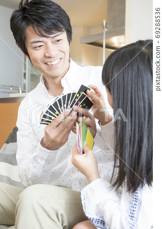 Parents and children playing card games 69288536