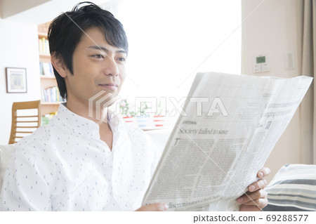 A man reading a newspaper A man reading a newspaper 69288577