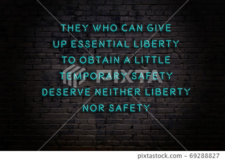 Wise quote. Neon inscription against brick wall 69288827
