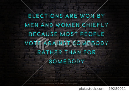 Wise quote. Neon inscription against brick wall 69289011