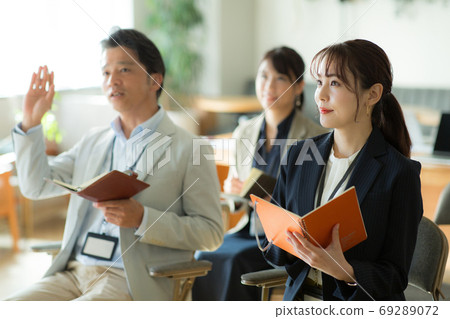 Business woman attending a seminar Business woman attending a seminar 69289072