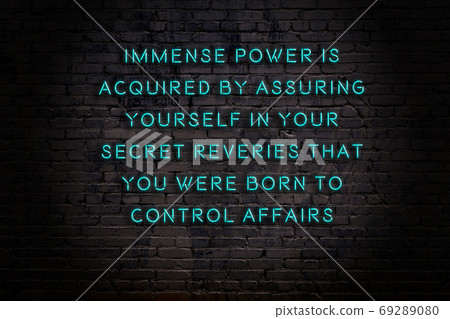 Wise quote. Neon inscription against brick wall Wise quote. Neon inscription against brick wall 69289080