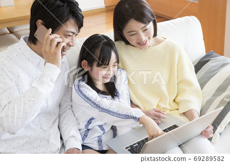 Family calling while looking at a computer Family calling while looking at a computer 69289582
