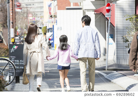 Rear view of parent and child going out 69289602