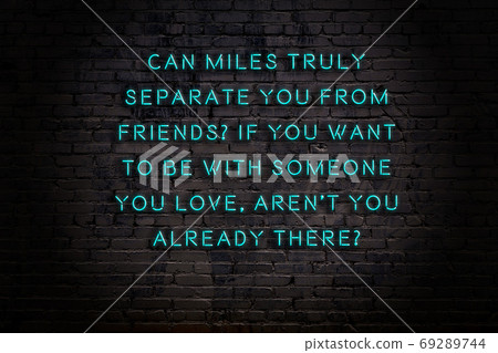 Wise quote. Neon inscription against brick wall 69289744