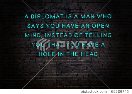 Wise quote. Neon inscription against brick wall Wise quote. Neon inscription against brick wall 69289745