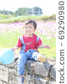 A child playing in a flower garden (cosmos) A child playing in a flower garden (cosmos) 69290980