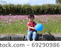 A child playing in a flower garden (cosmos) A child playing in a flower garden (cosmos) 69290986