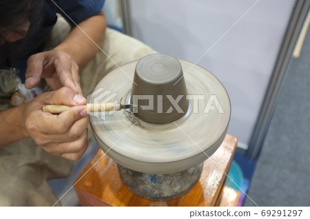 Concept Ceramic workshop. The man Throwing clay bowl on a pottery's wheel. Concept Ceramic workshop. The man Throwing clay bowl on a pottery's wheel. 69291297
