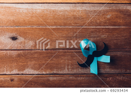 Light blue ribbon with a man mustache on wooden Light blue ribbon with a man mustache on wooden 69293434