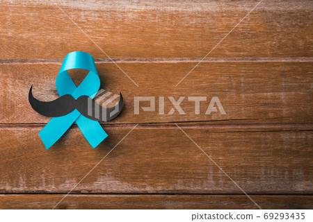 Light blue ribbon with a man mustache on wooden Light blue ribbon with a man mustache on wooden 69293435