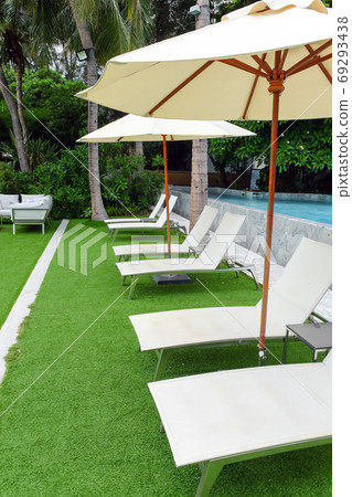 Image of Chaise longue at the pool in tropical resort Image of Chaise longue at the pool in tropical resort 69293438